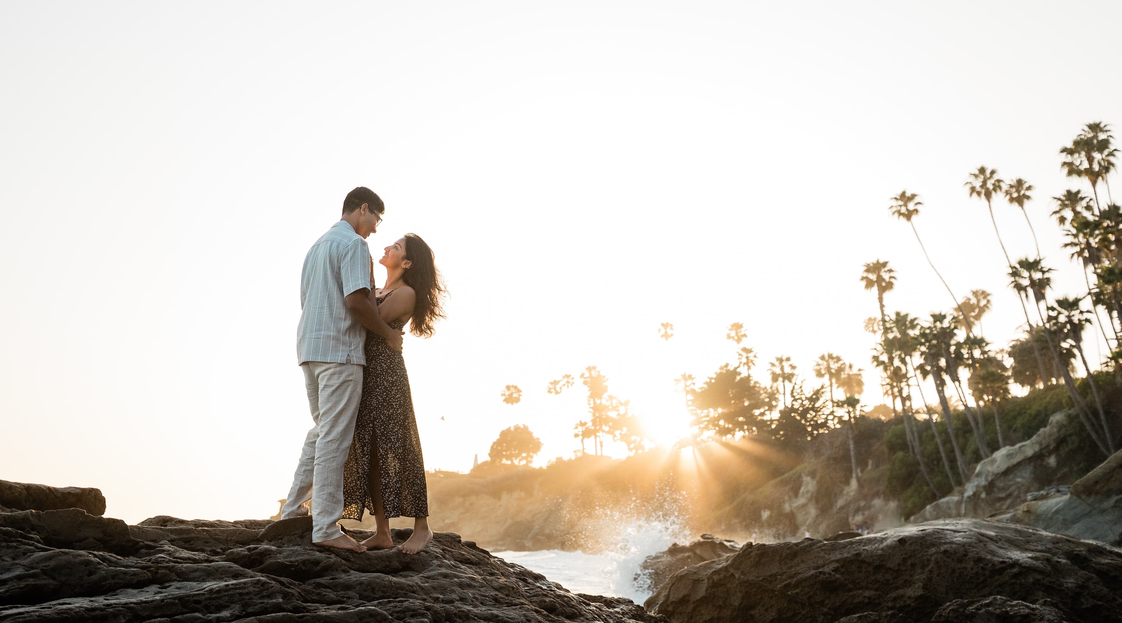Riddhi and Rishabh on the rocks at Laguna Beach at sunset